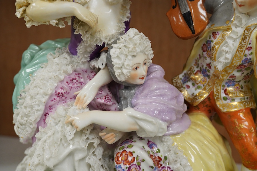A large German porcelain group of ladies and a violinist, early 20th century, 23cm high